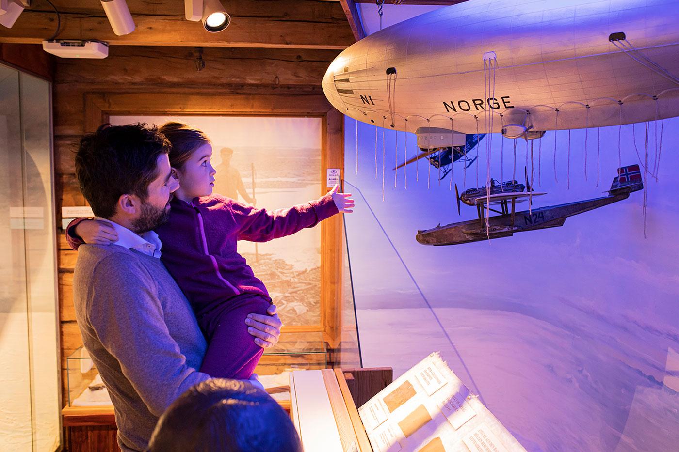 Visitors looking at a model of the Norge airship in the Polar Museum