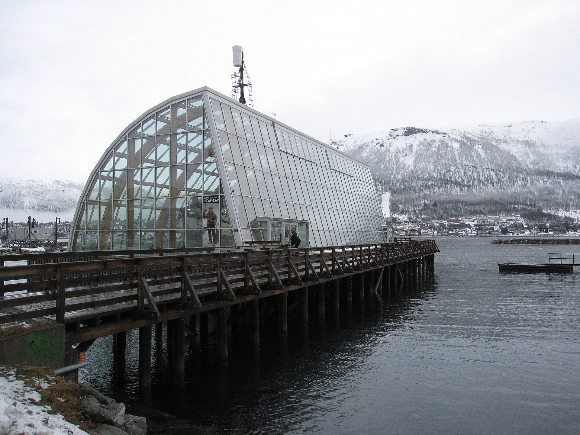 The glass enclosure of MS Polstjerna beside the Tromsø waterfront in winter