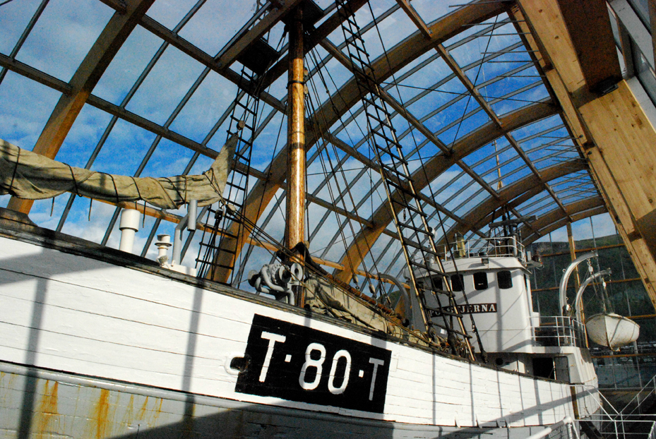The MS Polstjerna museum ship inside its glass enclosure by the Tromsø waterfront