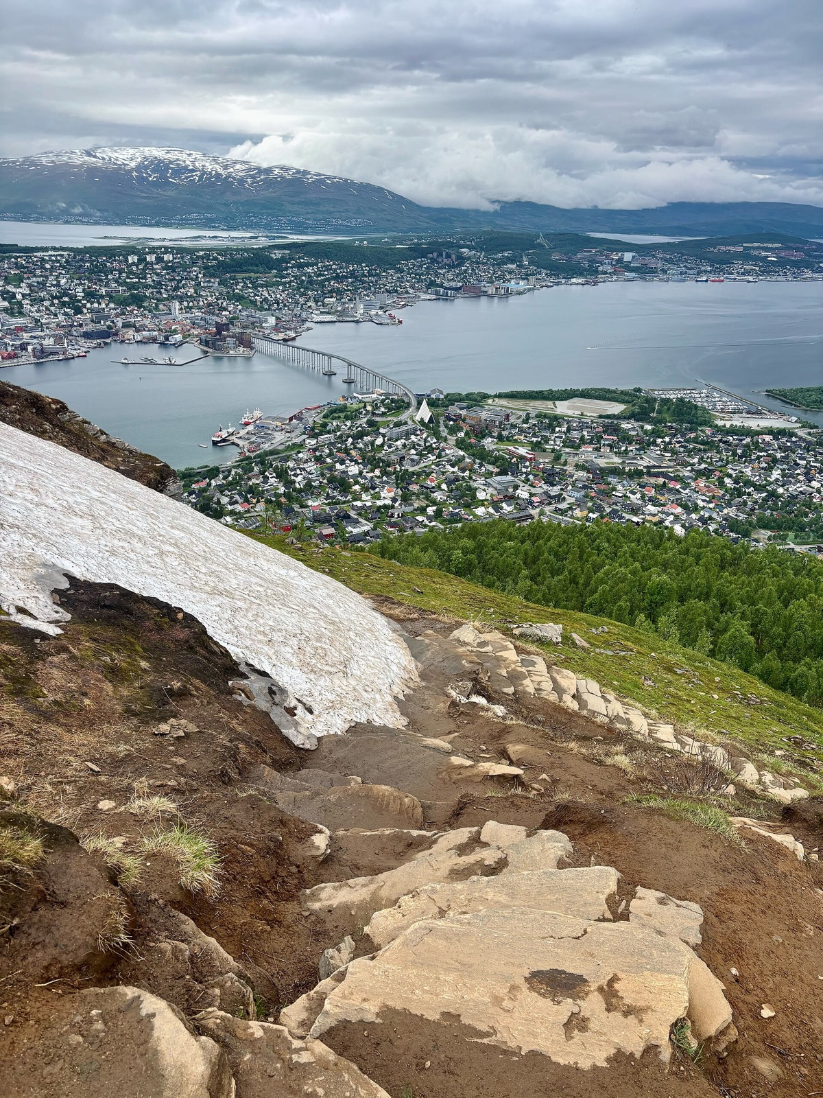 Sherpa Stairs above Tromsø with a patch of snow beside the steps in June