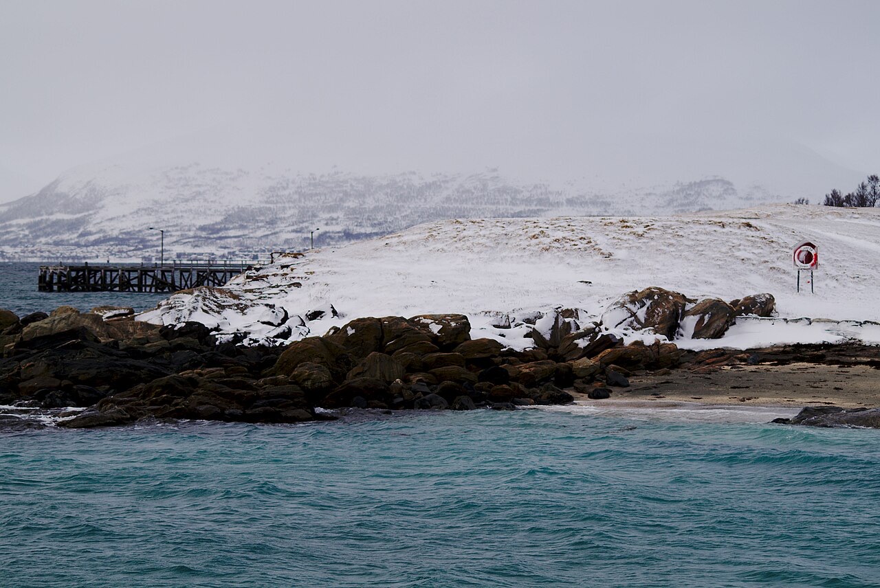 Snow-covered shoreline and small jetty at Telegrafbukta in winter