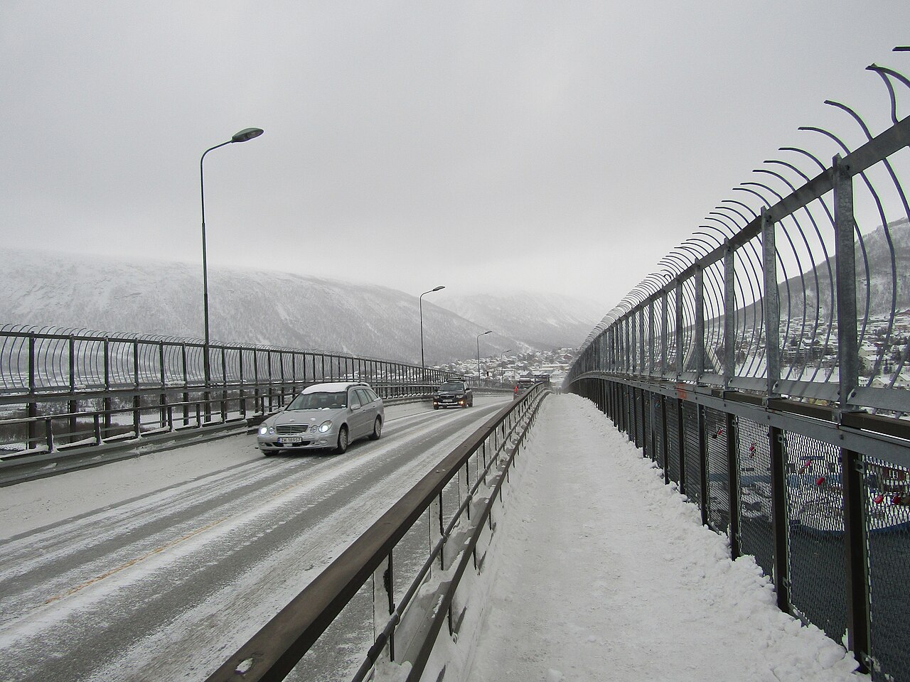 Snow on the pedestrian path of Tromsø Bridge during a 2017 winter crossing