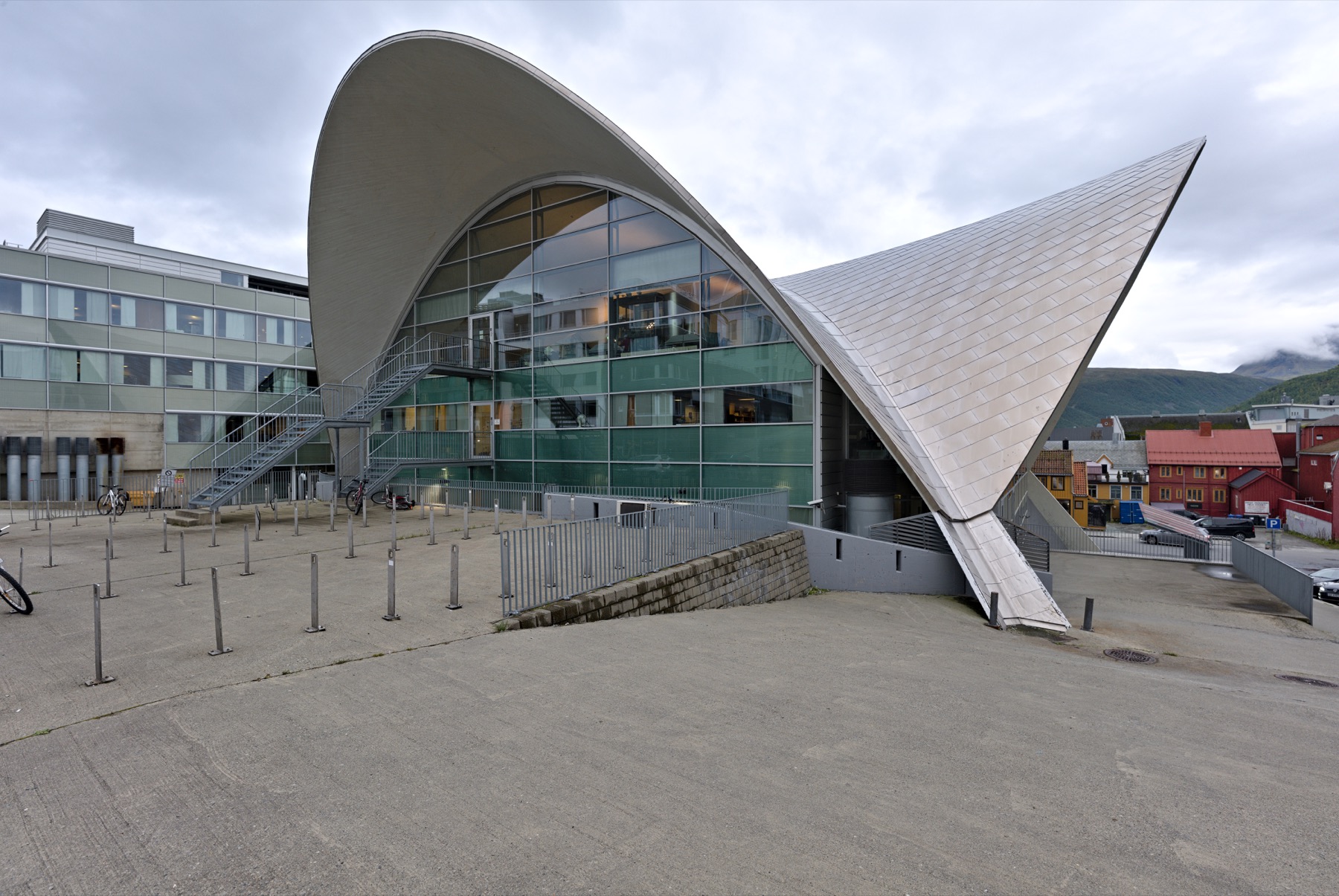 The curved roof and glass facade of Tromsø Library and City Archives