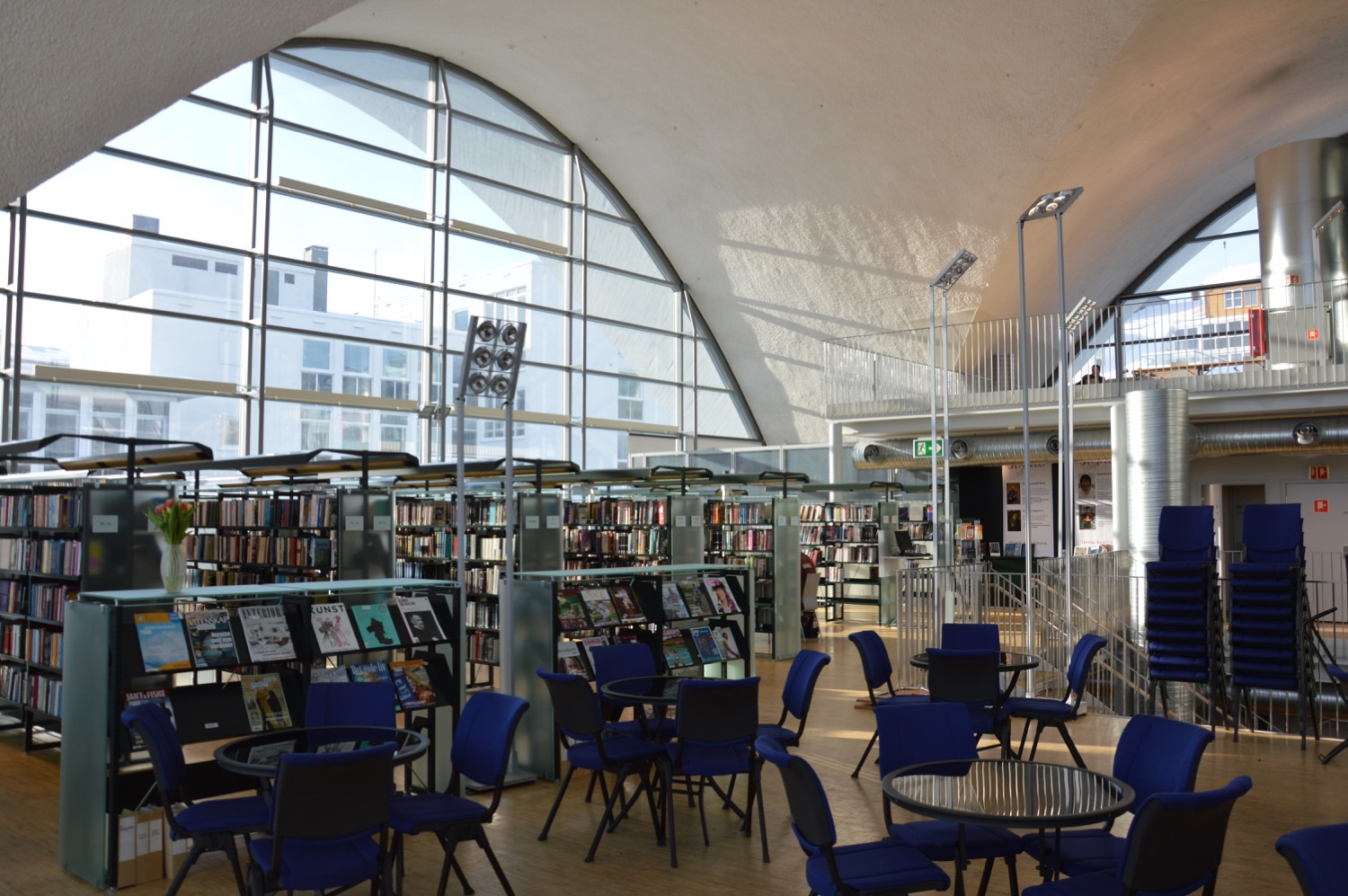 Bookshelves and seating beneath the curved roof inside Tromsø Library