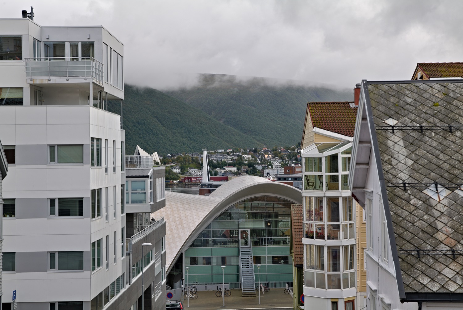 Tromsø Library roof seen above its glass wall from a nearby street