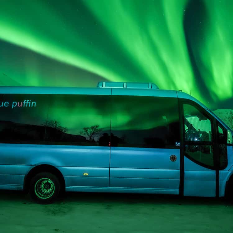 Minibus beneath northern lights; illustrative photo, not the shortlisted operator’s vehicle