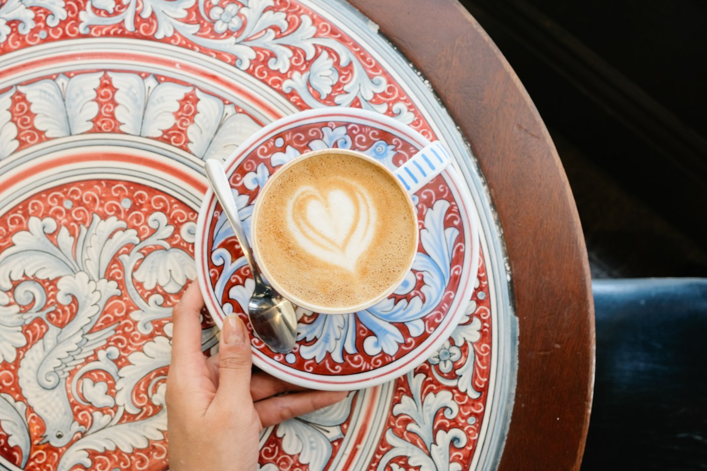 A cup of coffee on a patterned table; illustrative photograph taken outside Tromsø