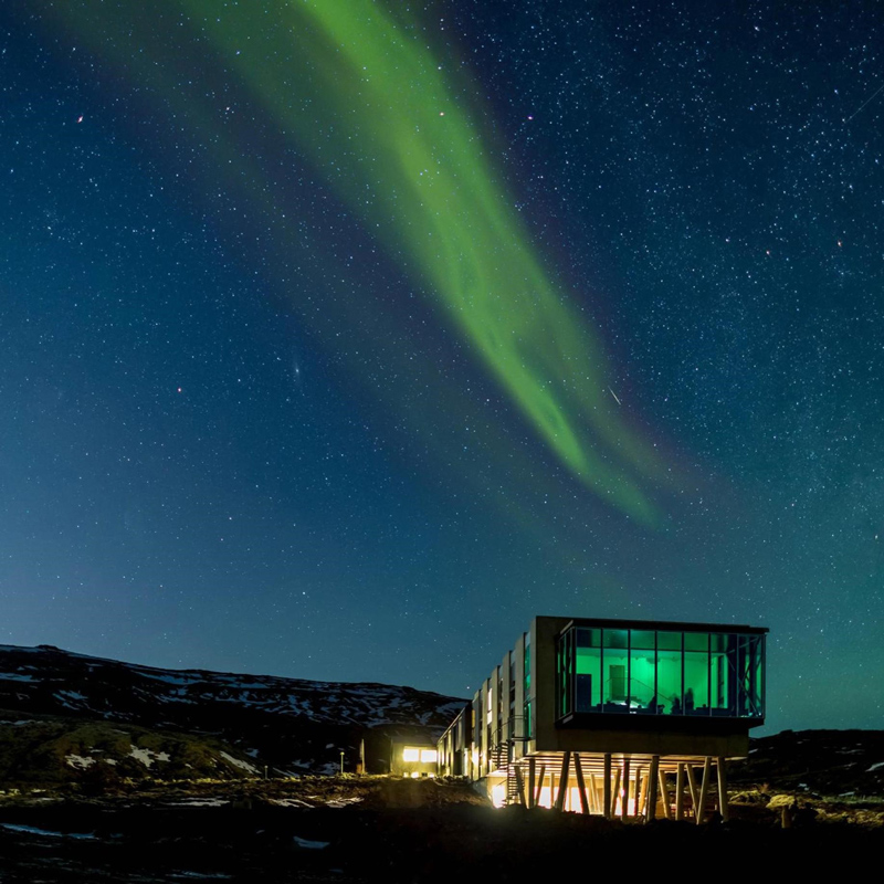 Glass-fronted accommodation beneath the northern lights