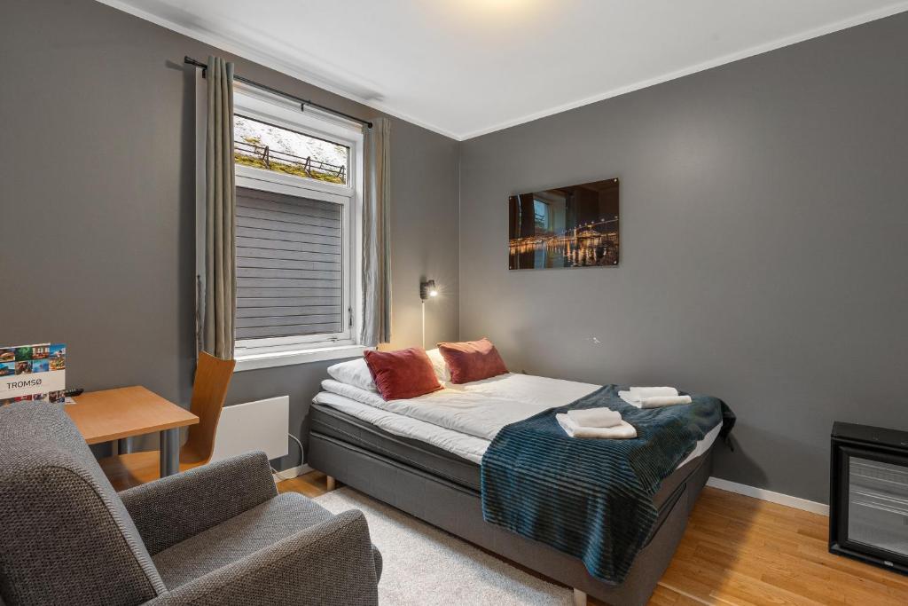 First Hotel Backpack: bedroom with chair and window — First Hotel Backpack