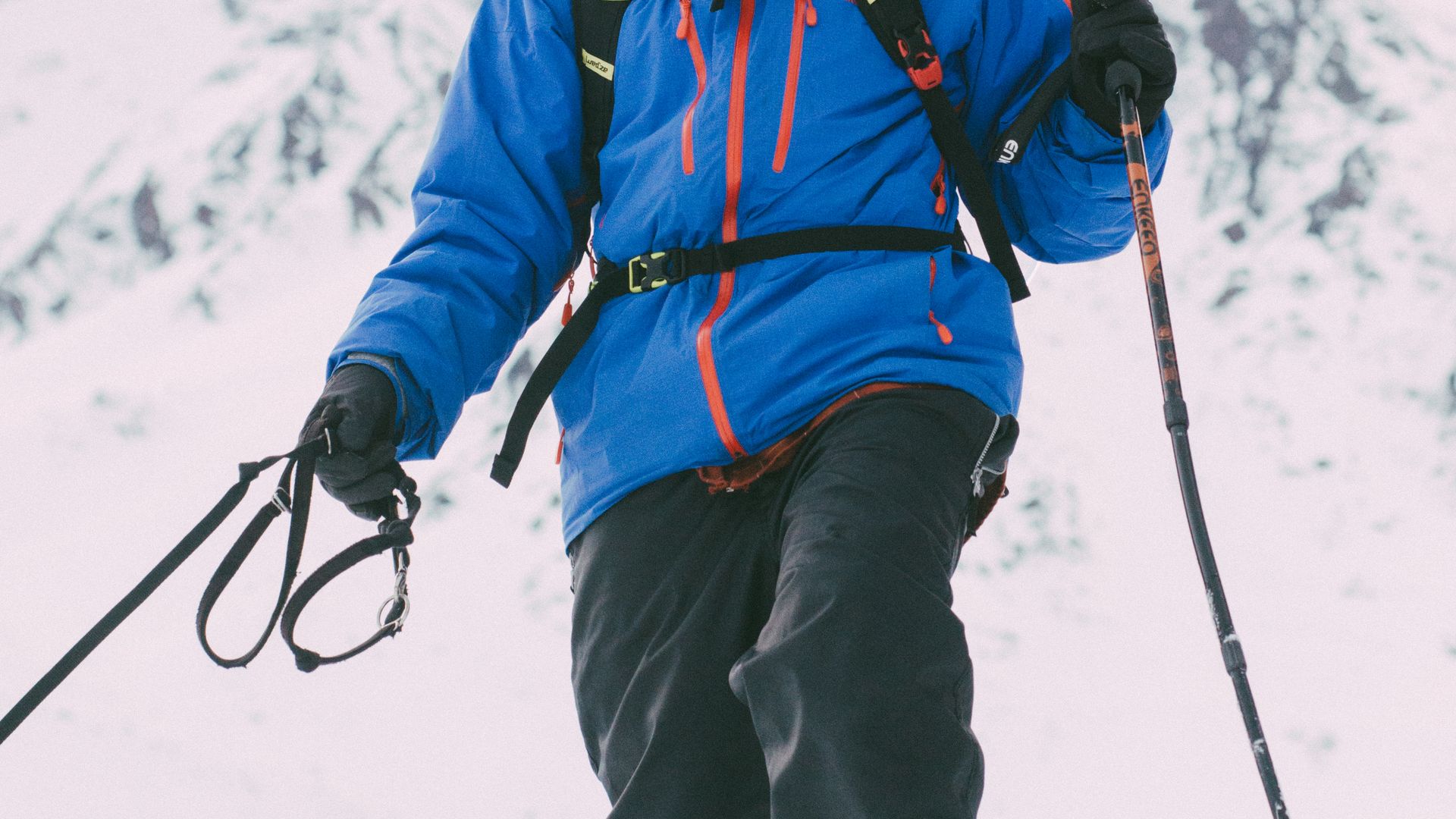Person snowshoeing in snowy mountains