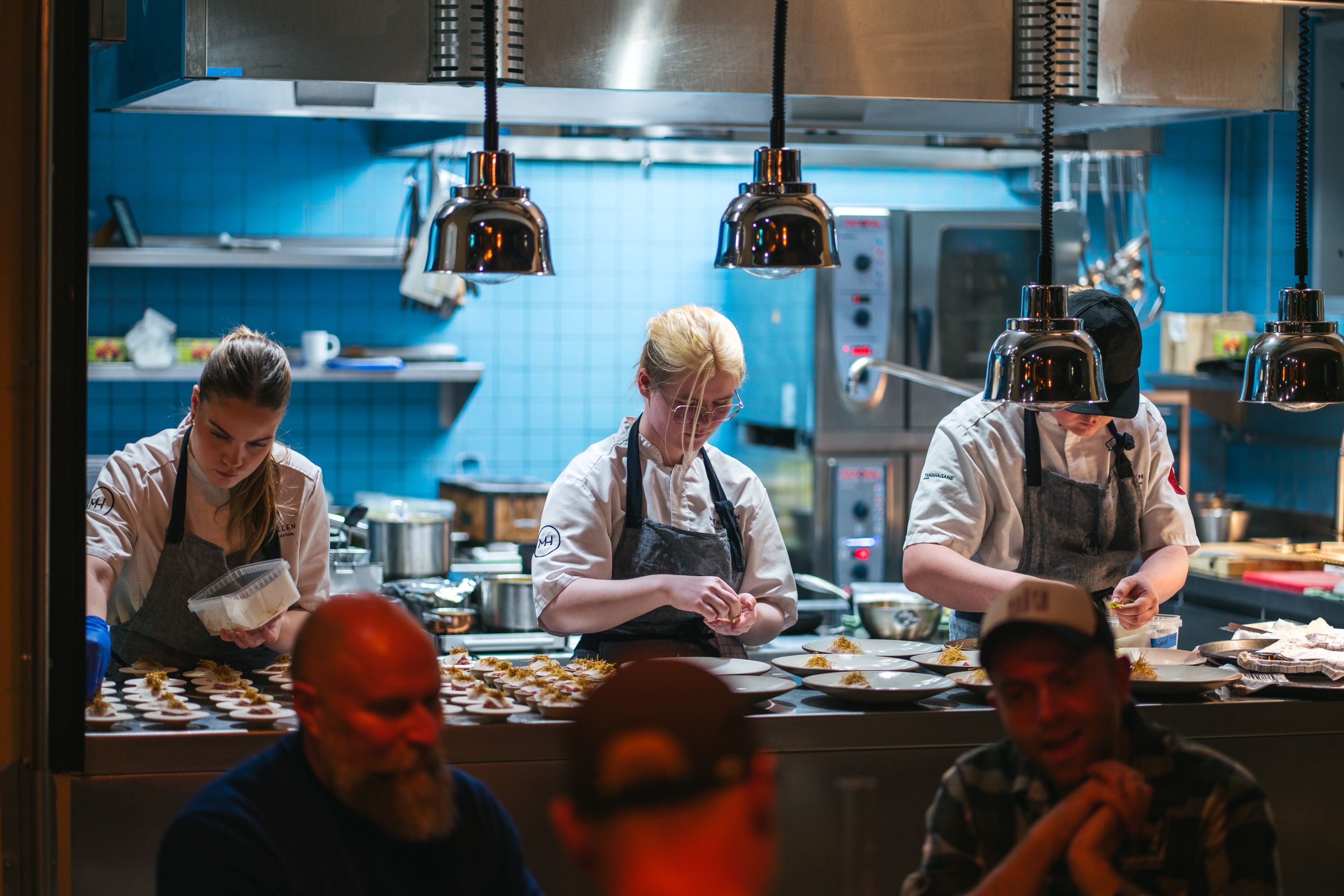 Chefs at work in the open kitchen at Mathallen Tromsø