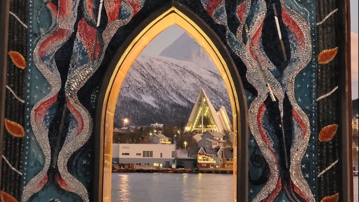 Arctic Cathedral seen through a decorated arch from Tromsø waterfront