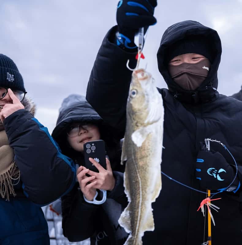 Guests fishing from a boat in the waters outside Tromsø — photo 1 of 5