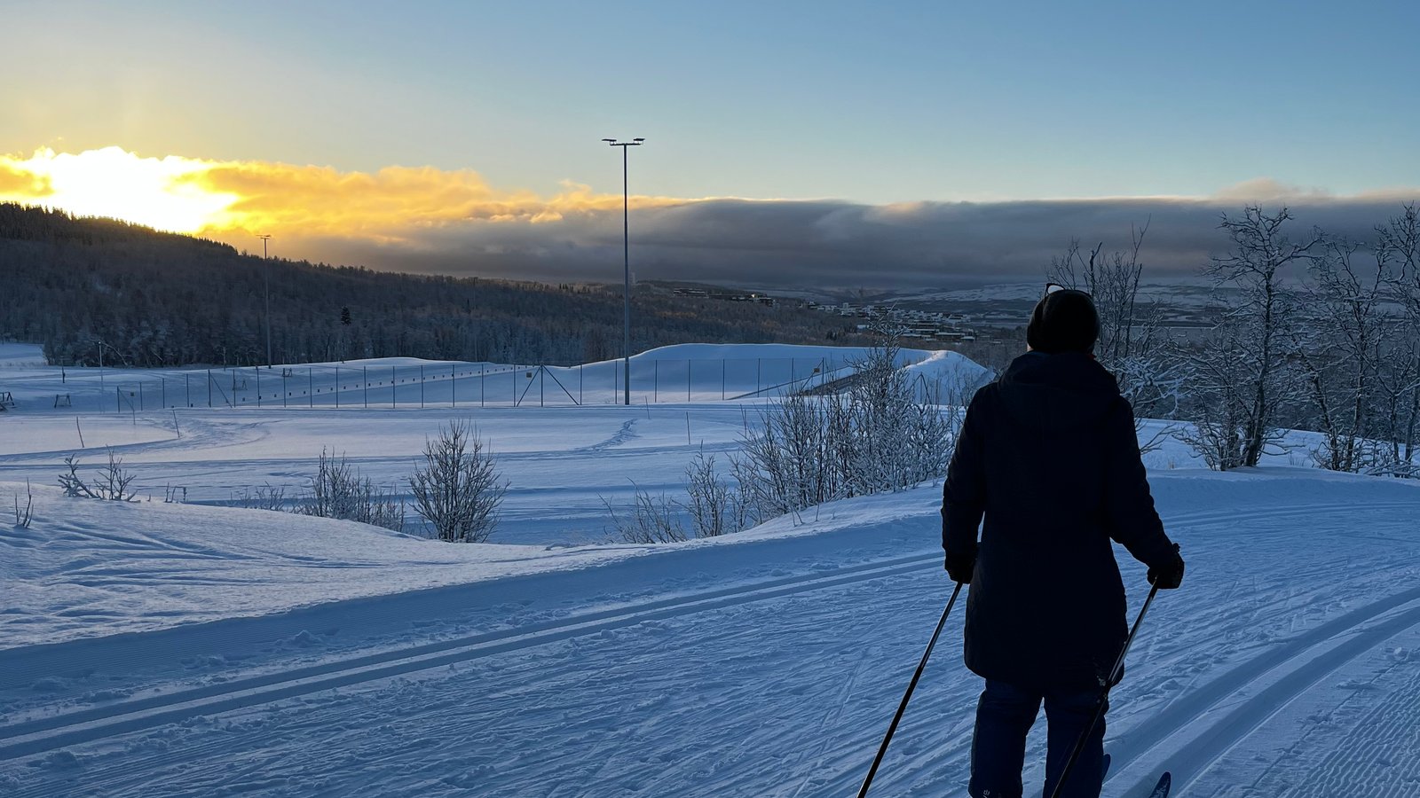 Beginner learning cross-country skiing on a snowy Tromsø trail