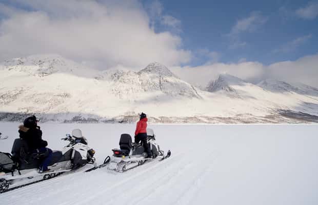 Snowmobile group riding below the Lyngen Alps — photo 1 of 5